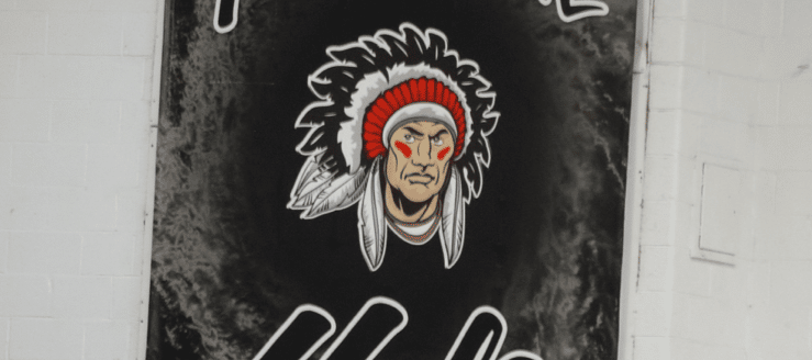 Carrollton Warrior Logo Black Hole Banner in Gym