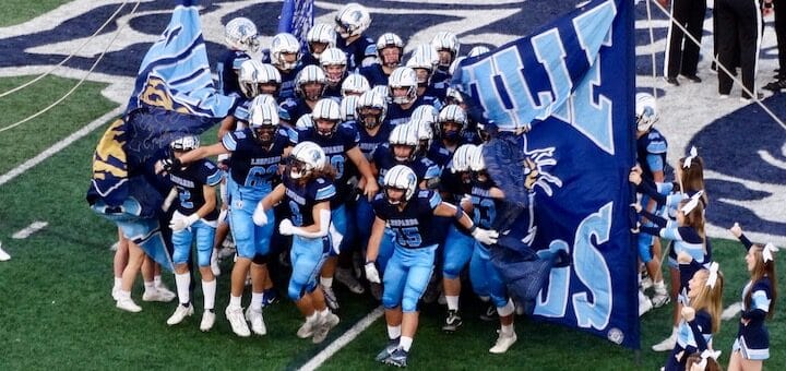 Louisville Leopards Football Team 2022 Running Through Banner